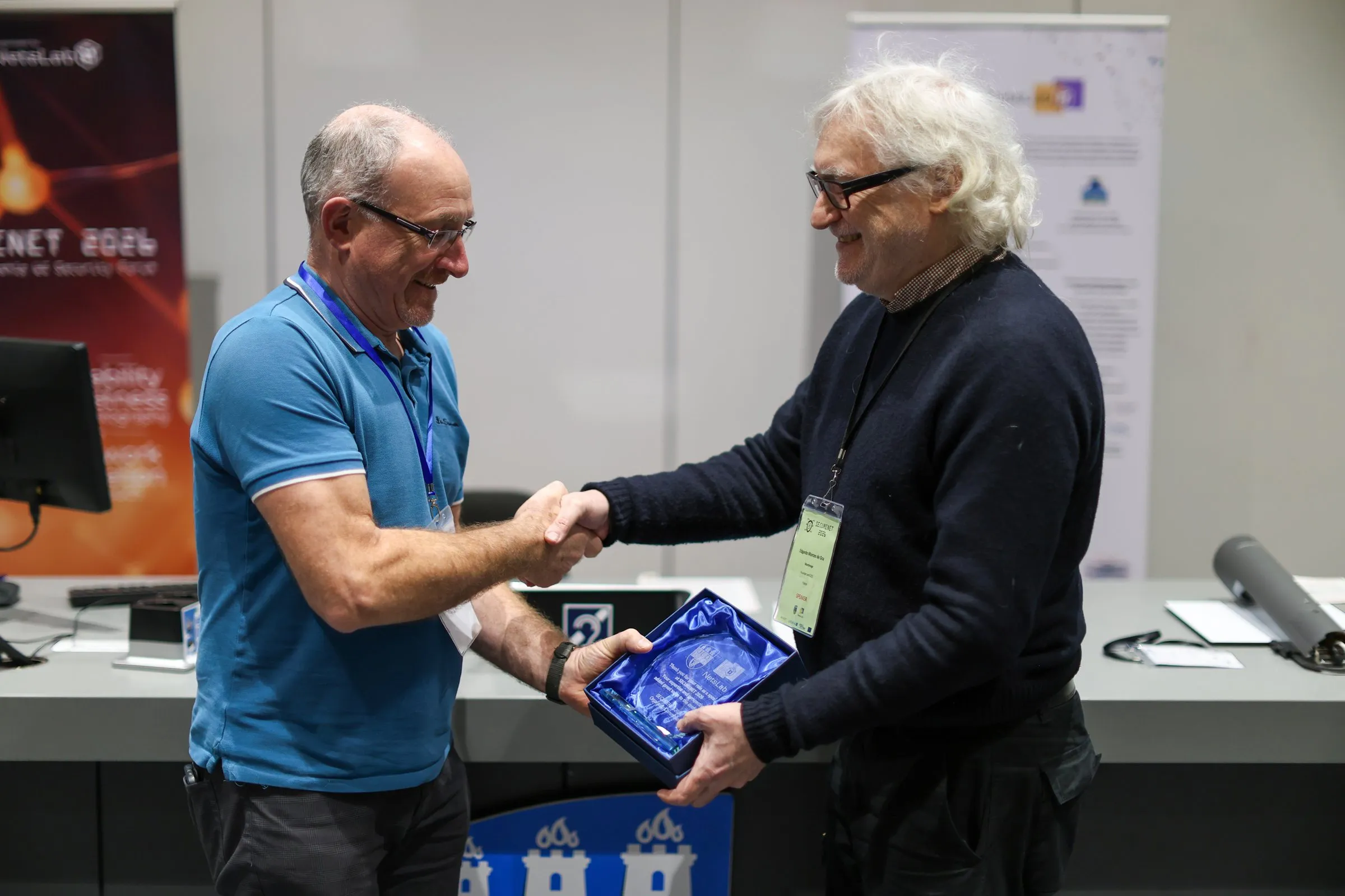 A speaker receiving an award at SECURENET 2026
