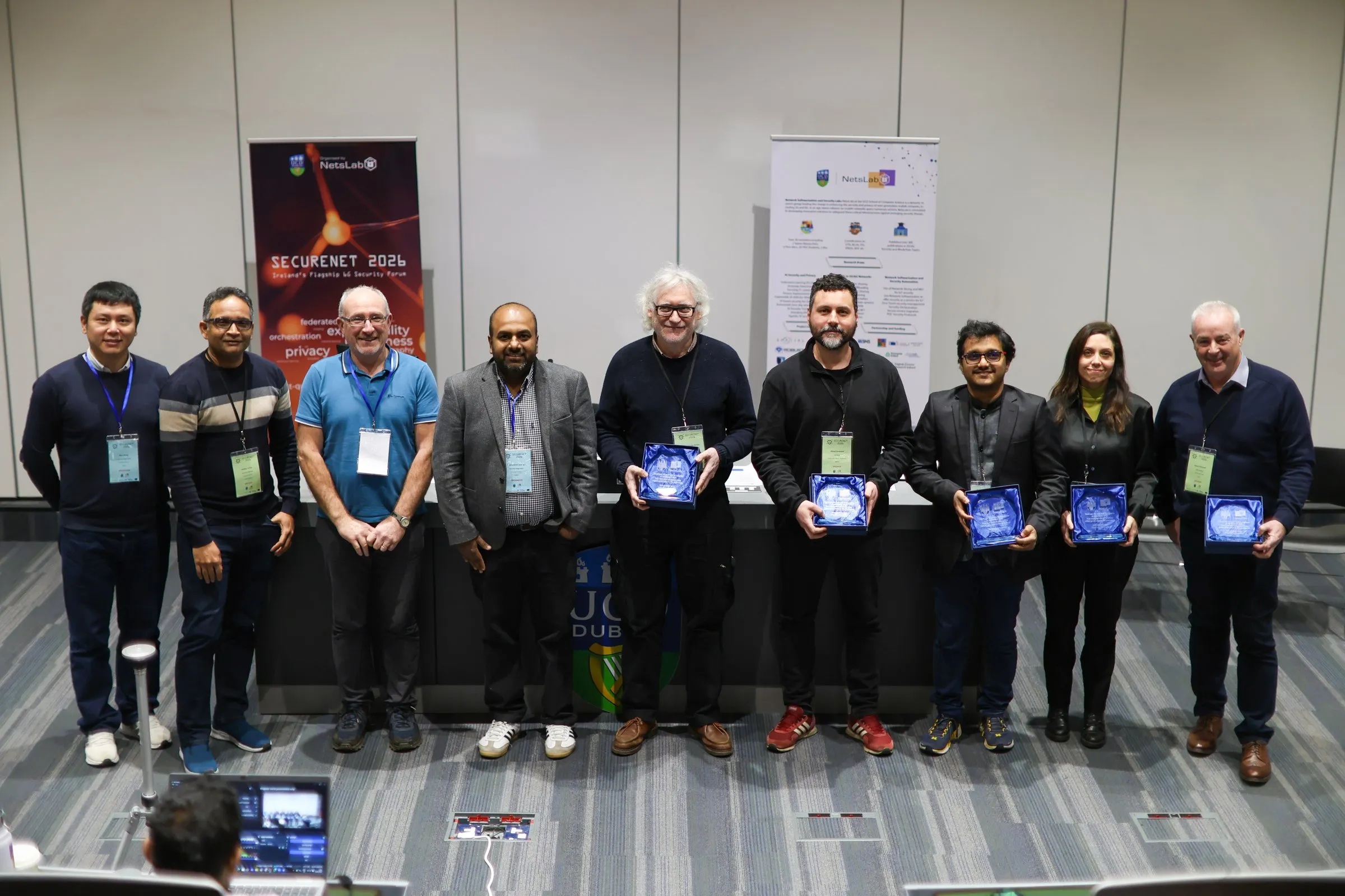Speakers and organisers holding awards in front of the SECURENET 2026 banners